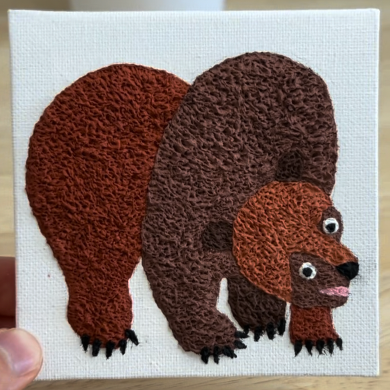 Handmade brown bear patch on a white background